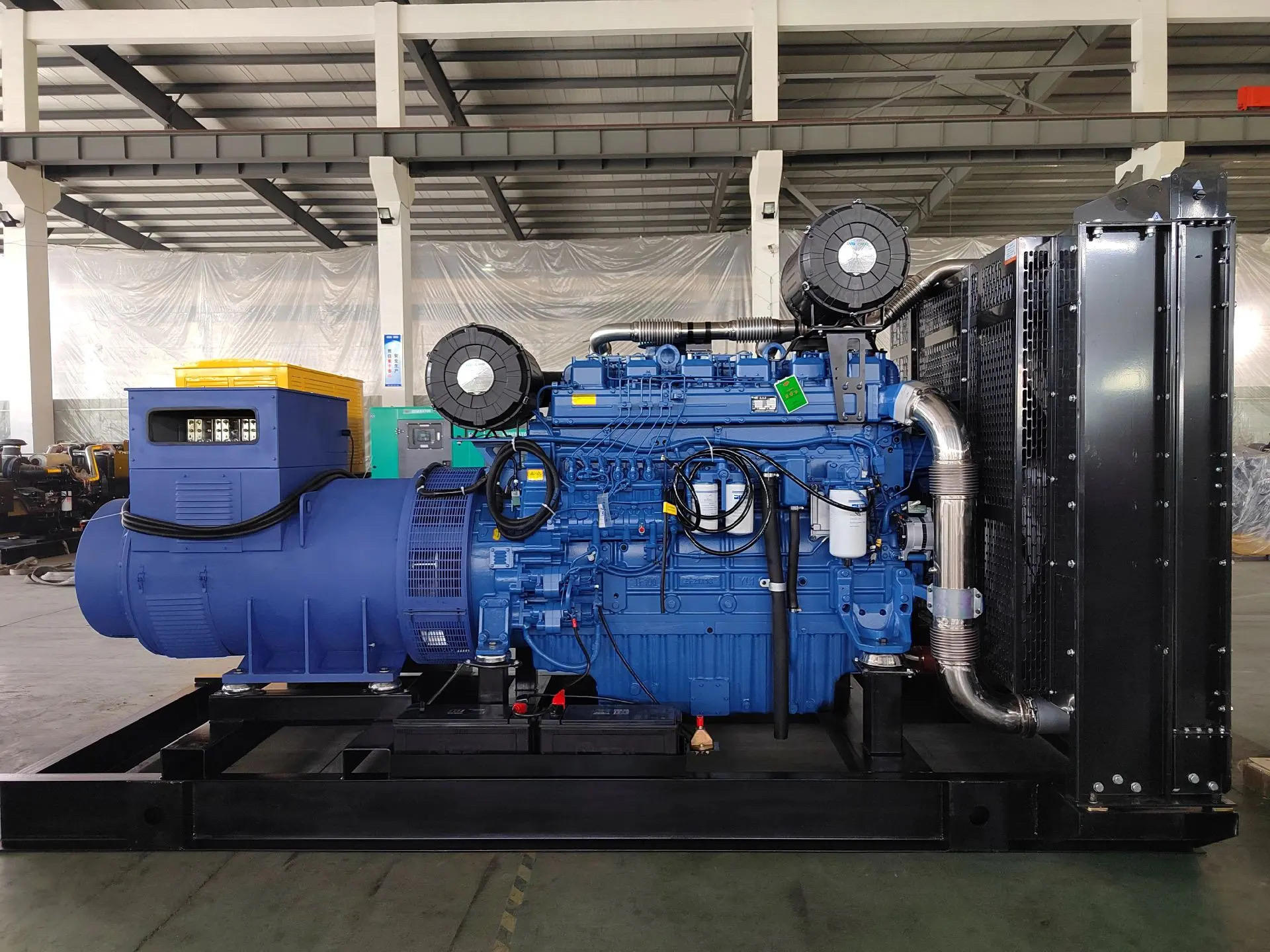 Open frame diesel generator set on a steel skid with the fuel line and filter visible beside the engine block