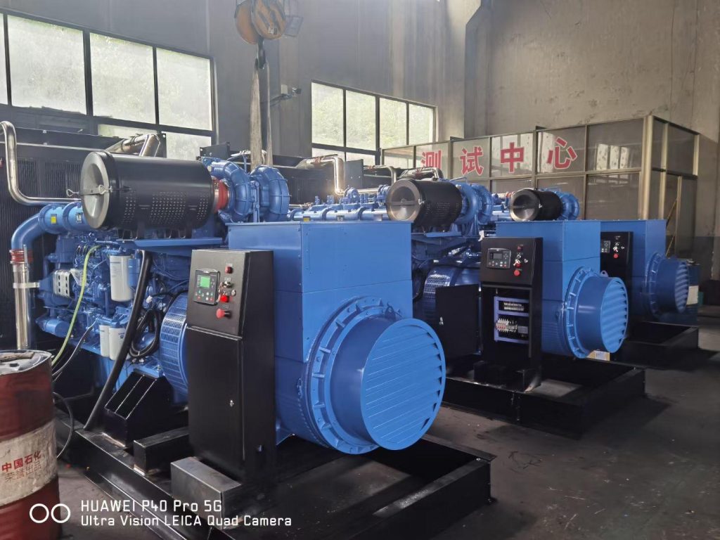 Row of blue open diesel generator sets with control panels in a factory test bay during a load run
