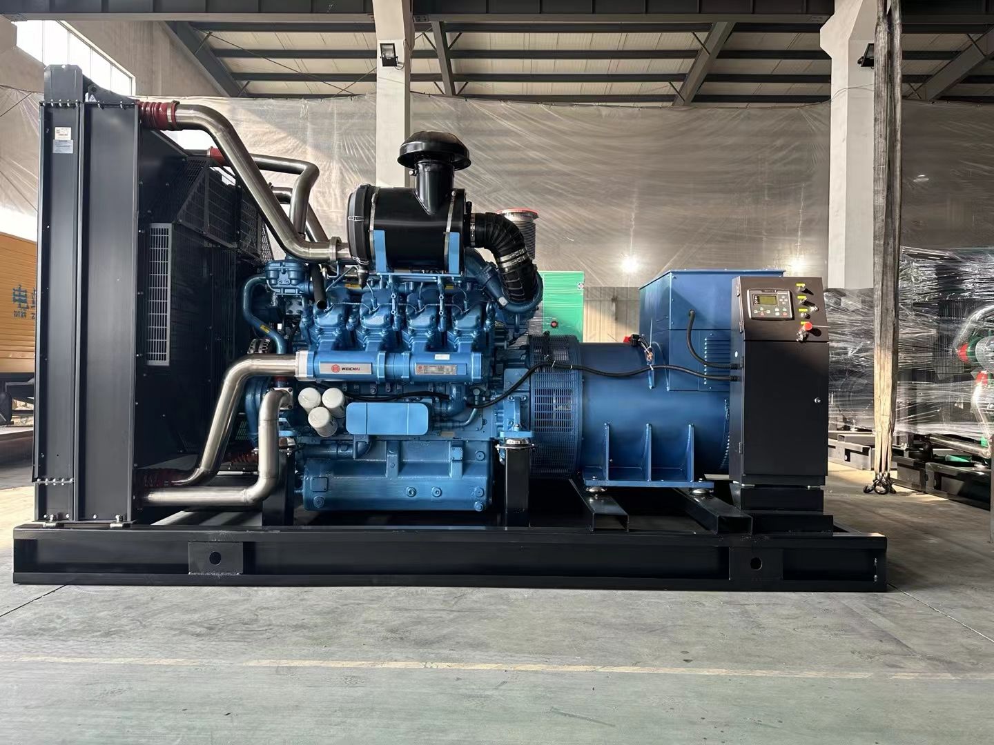 Open-frame diesel generator set on the shop floor with its engine and alternator fitted before packing for export