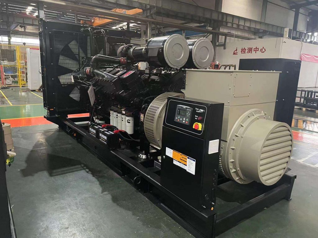 Open-frame diesel generator set in a factory test bay with the control panel and alternator terminal box at the right end
